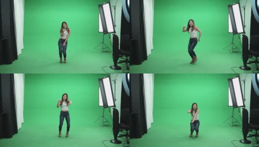 亚洲女孩在绿色背景上跳舞高清在线视频素材下载