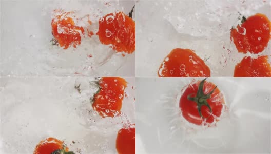 几个红色的西红柿掉进水里。白色背景高清在线视频素材下载