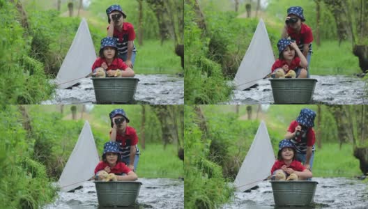可爱的孩子们，男孩兄弟，在小河上玩船和鸭子，航行和划船。孩子快乐，童年幸福理念高清在线视频素材下载