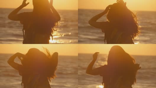 日落时分，年轻的女游客在海边扎马尾辫。日出时，美丽的女孩在海边捏着自己的头发。女背包客编织头发和做发型。护发高清在线视频素材下载