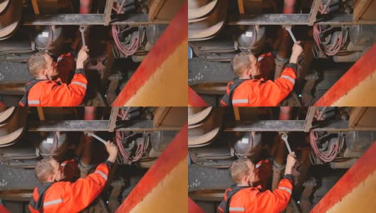 机修工修理卡车的底部高清在线视频素材下载