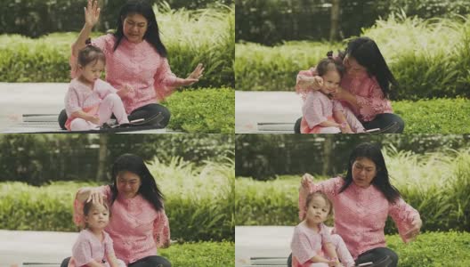 亚洲的祖母和孙女在花园里唱歌跳舞高清在线视频素材下载