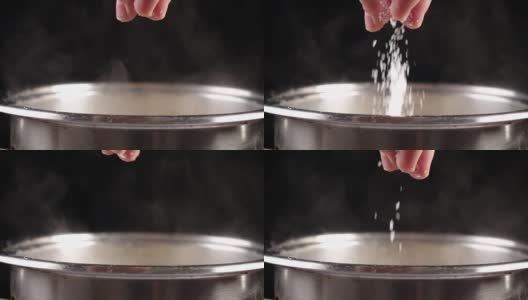 金属锅中加入盐到沸水中，慢动作高清在线视频素材下载