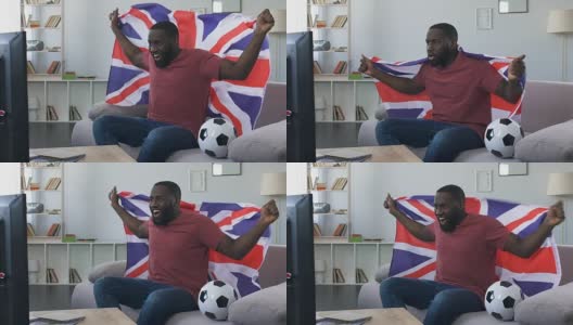 英国球迷挥舞旗帜为国家队加油，在家看比赛高清在线视频素材下载