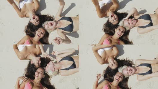 Top Angle View Of Three Girls Lying On Beach Laughing, Enjoy Sun Tan Talking, Womem Happy Tourists On Summer Holiday高清在线视频素材下载