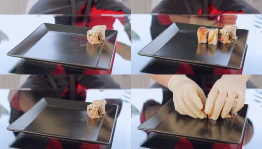 寿司卷把寿司放在一个黑色的盘子里高清在线视频素材下载