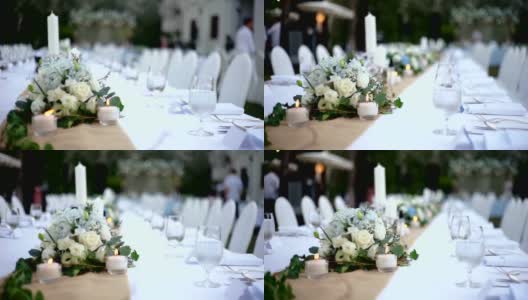 MS Dolly右边的婚宴餐桌上装饰有鲜花和蜡烛，供客人使用。高清在线视频素材下载