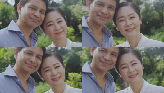 幸福的亚洲资深夫妇肖像与美丽的家花园的背景。高清在线视频素材下载