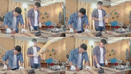 木匠正在用刨床。男木匠在木工车间使用刨床。高清在线视频素材下载