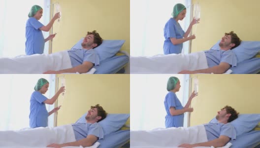 白种女护士为躺在康复室床上的男性病人提供生理盐水滴注调整服务。医院专业职业卫生保健和医疗服务。高清在线视频素材下载