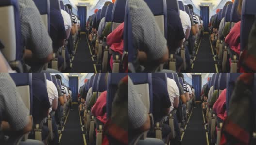 在飞机内部的座位上不认识的乘客高清在线视频素材下载