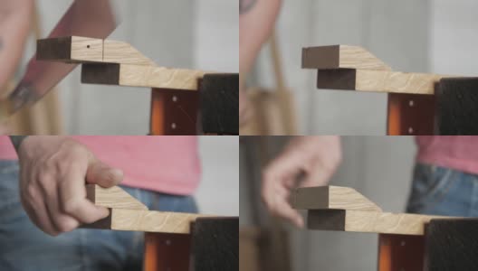 木匠用手锯锯一块橡木板。用手锯从橡木板上锯一块木头的木匠。手工木工工具在工作。木工的艺术。手工木工工具的声音高清在线视频素材下载