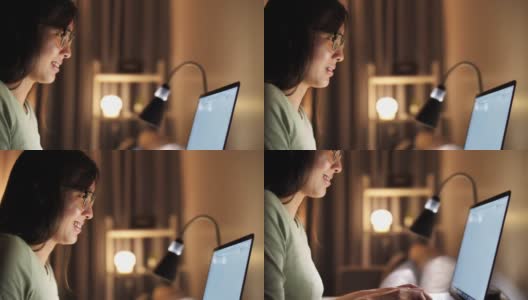 女人晚上在家使用笔记本电脑高清在线视频素材下载