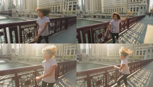 快乐的非裔美国妇女跳过芝加哥河上的一座桥高清在线视频素材下载