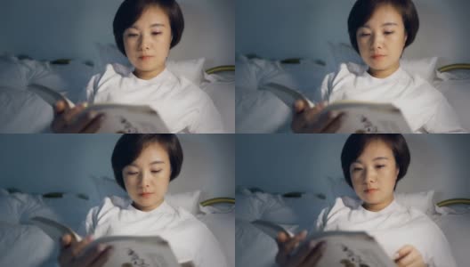 晚上躺在床上看书的亚洲女人高清在线视频素材下载