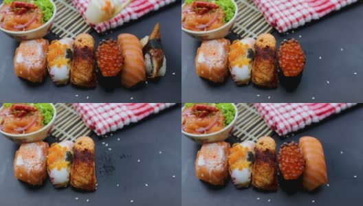 日本食品成分。各种寿司放在黑板上。辣泡菜三文鱼色拉配筷子。高清在线视频素材下载
