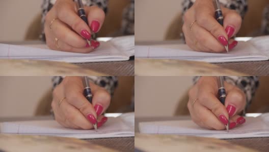 一个女人在笔记本上写手写的文字高清在线视频素材下载