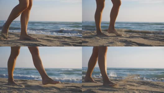 女性的脚踩在沙滩上的特写与海浪的背景。一个美丽的女人在阳光明媚的日子赤脚走在海边。暑假或假期的概念。慢动作低角度视图高清在线视频素材下载