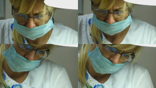 近距离拍摄的女医生戴着防护眼镜的肖像。女性戴着医用口罩。美容师或治疗师在工作高清在线视频素材下载