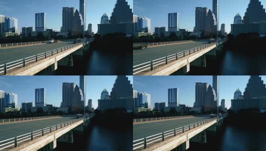 德克萨斯州奥斯汀阳光明媚的早晨靠近国会桥，早上骑自行车的人和汽车在上班的路上高清在线视频素材下载