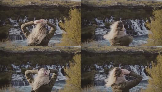 年轻的旅行女人的背影站在山谷和看瀑布在冰岛独自高清在线视频素材下载