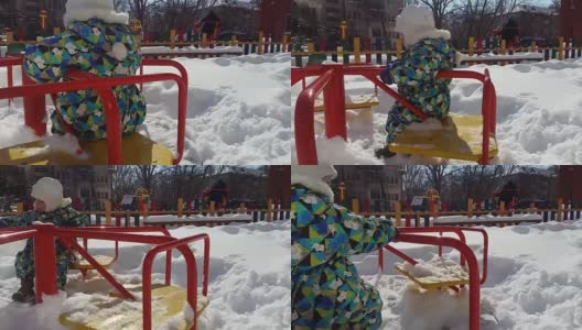 儿童游乐场有跷跷板，滑块，木梯，旋转木马。冬天废弃的操场下着雪，在公园里慢慢地下雪。高清在线视频素材下载