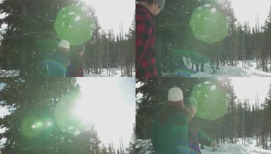 慢动作拍摄的一对年轻的爱的夫妇在一起散步，而手牵手在一个下雪的日子。然后镜头向上平移高清在线视频素材下载