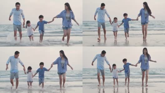幸福的一家人在海滩上散步。快乐的一家人在海滩上享受暑假。假期——iStock高清在线视频素材下载