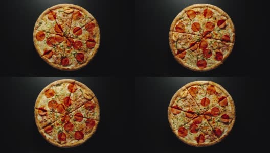 延时:大披萨的圆圈在一个黑色的表面上快速旋转高清在线视频素材下载