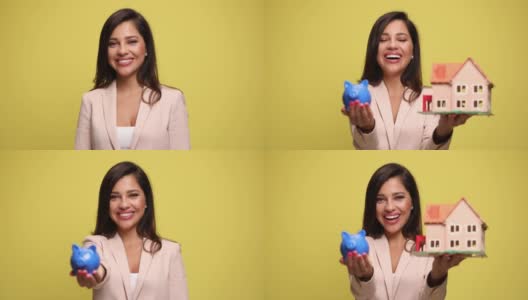 女商人拿着一个储蓄罐和一个房子模型，微笑着表示赞许高清在线视频素材下载