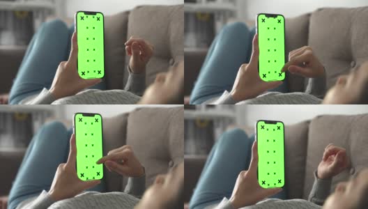 女人在用绿色屏幕的智能手机高清在线视频素材下载