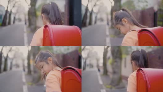 小日本女学生在住宅区樱花树下步行上学高清在线视频素材下载