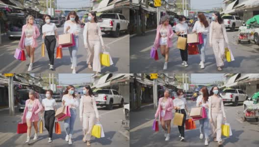 4K群亚洲女性朋友带着医用口罩一起逛街市。高清在线视频素材下载