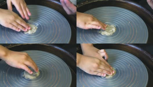 孩子们的手准备一个陶工轮，把粘土坯放在上面高清在线视频素材下载