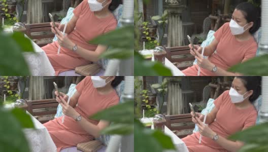 一位怀孕的亚洲妇女坐在咖啡店里摸着自己的肚子高清在线视频素材下载