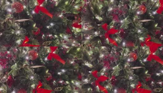 垂直镜头的圣诞装饰闪耀在白雪覆盖的云杉树枝上，红色的花楸和苹果的果实，绿色的树，红色的丝带，发光的花环高清在线视频素材下载