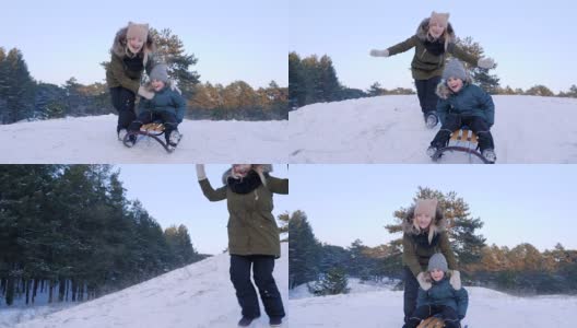 冬日里，快乐的年轻女子推着雪橇把儿子从雪山上拉下来，慢慢地跟在他后面跑高清在线视频素材下载