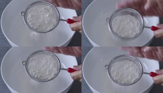 将面粉筛入白色搅拌盆中高清在线视频素材下载