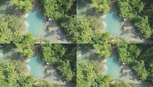 无人机航拍的年轻女子在热带瀑布游泳。4K分辨率的视频，在菲律宾拍摄。人们旅行乐趣度假冒险概念高清在线视频素材下载
