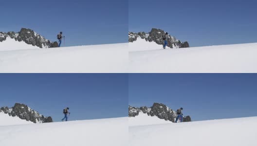 人沿雪岭上行上行景观。登山滑雪活动。冬季滑雪者在高山户外运动。侧视图。慢动作60p 4k视频高清在线视频素材下载
