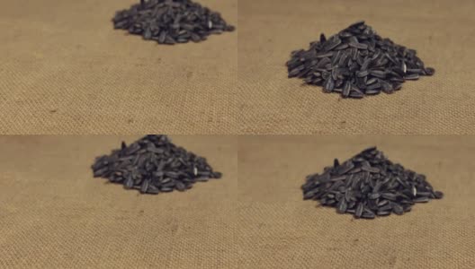 Zoom，走近的是一堆放在麻袋上的葵花籽。特写镜头高清在线视频素材下载