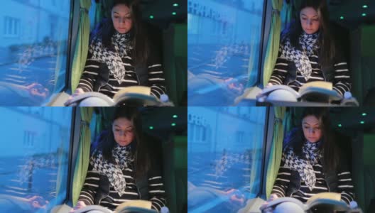 5 .一名女子在晚上旅行的公交车上看书高清在线视频素材下载