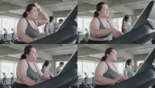 超重的年轻女子在跑步机上锻炼高清在线视频素材下载