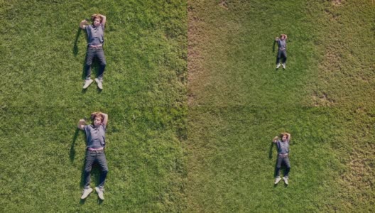 十几岁的男孩躺在草地上玩他的智能手机高清在线视频素材下载