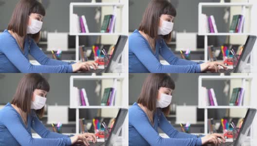 一位戴着面具的年轻女子在图书馆用电脑在家工作。冠状病毒对就业的影响。高清在线视频素材下载