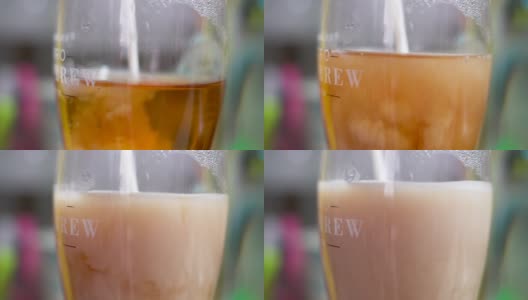 牛奶进冷泡茶彩色背景高清在线视频素材下载