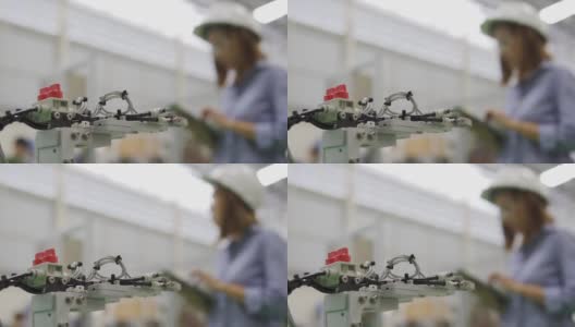 模糊亚洲女工业工程师在一顶安全帽使用数字平板电脑在工业工作地点高清在线视频素材下载