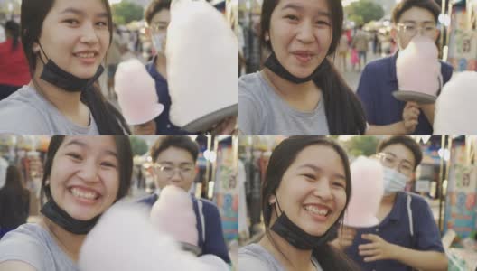 十几岁的男孩和女孩买棉花糖。街头食品泰国高清在线视频素材下载
