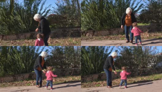 小女孩和老奶奶在公园里散步高清在线视频素材下载