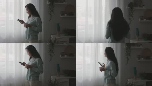 一名年轻女子看着窗外，一边喝咖啡一边发短信高清在线视频素材下载